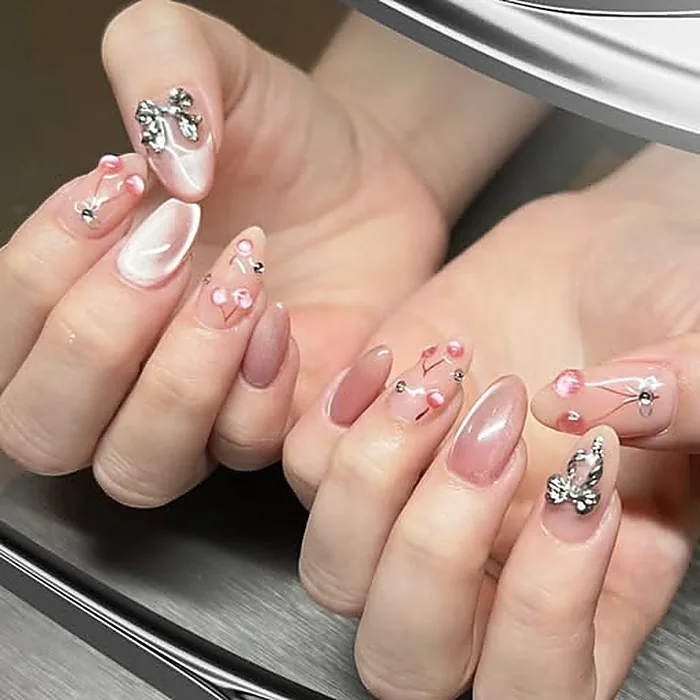 Nail art pink mutiara dengan pita dan kristal, gel extension Bogor